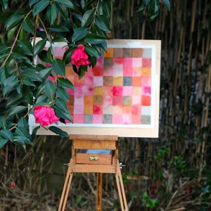 Art easel with painting by foliage