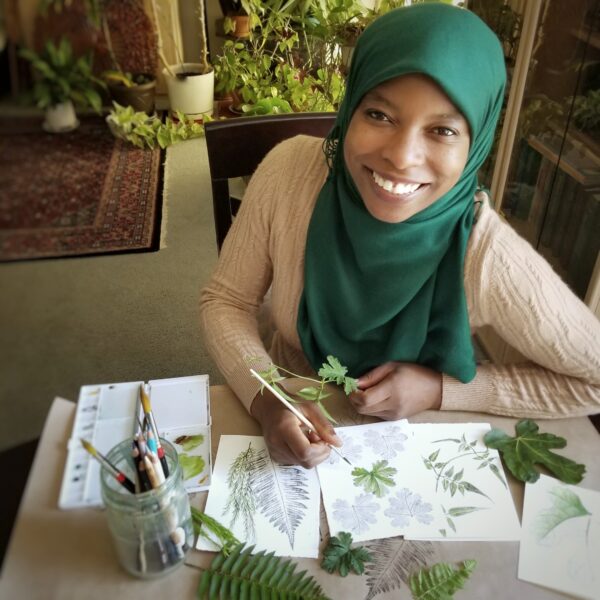 Latifat Apatira with artwork of botanical ink and leaves