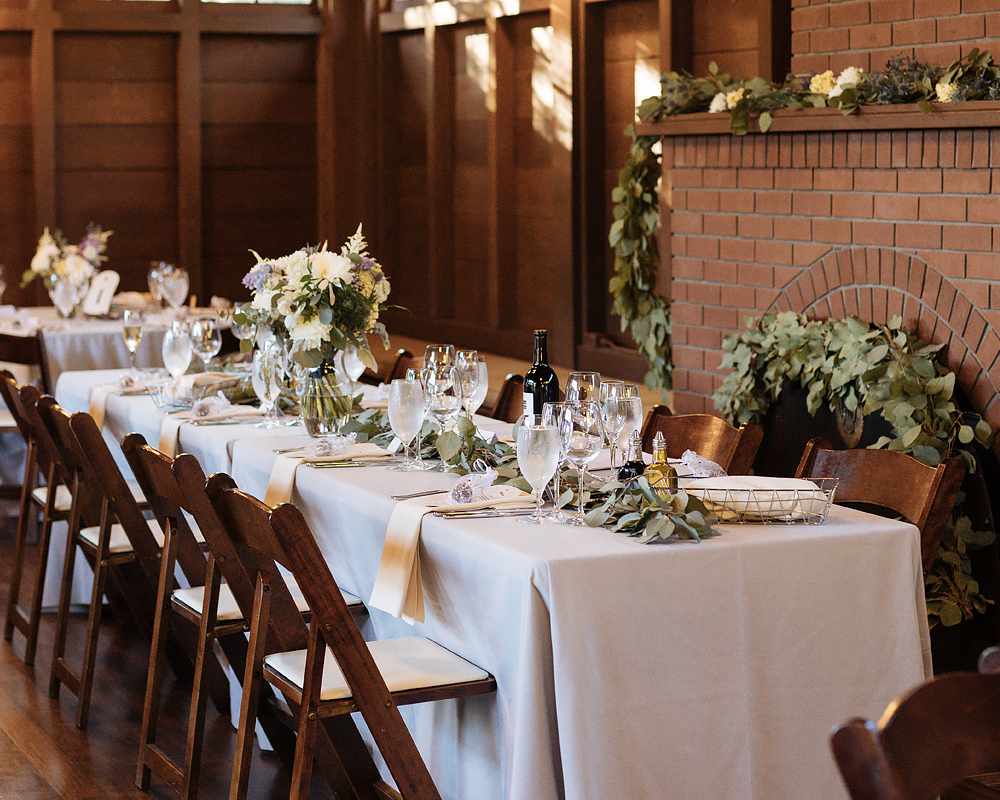 A long table with a white tablecloth and decorations ready for a party