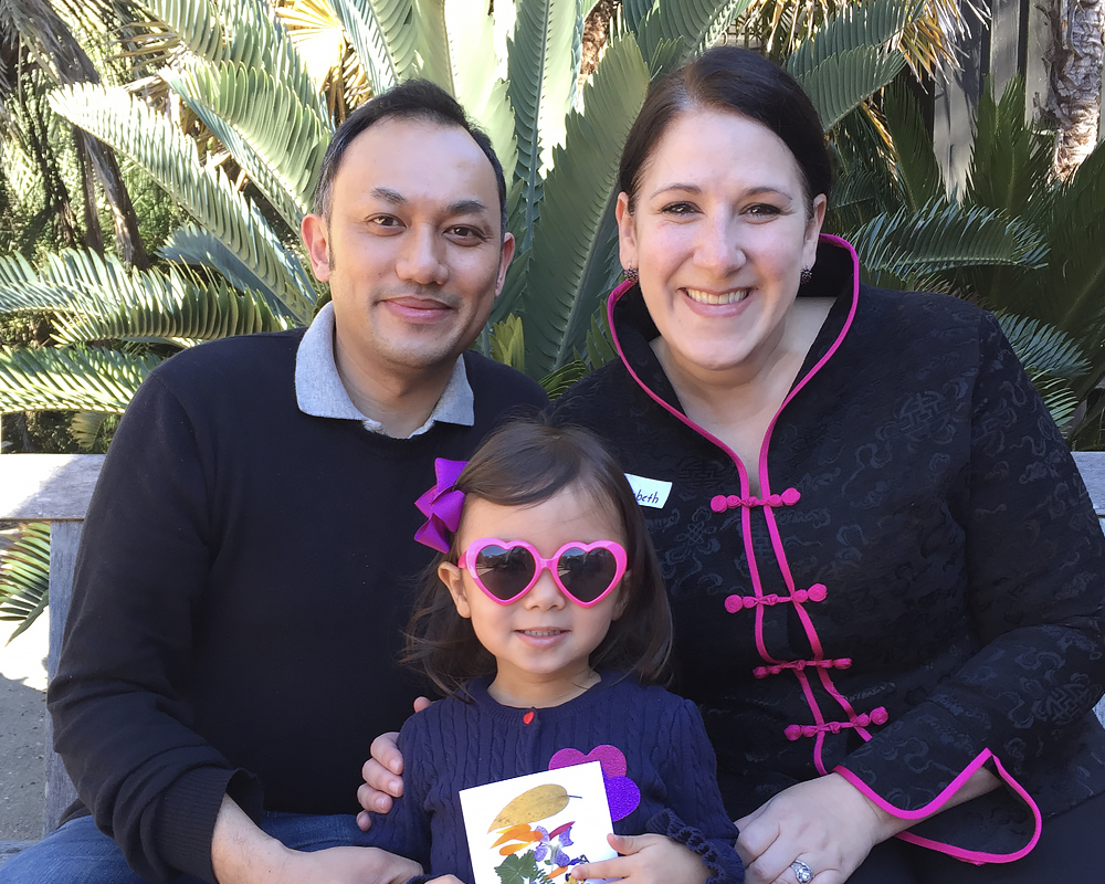 A smiling family enjoys the Garden