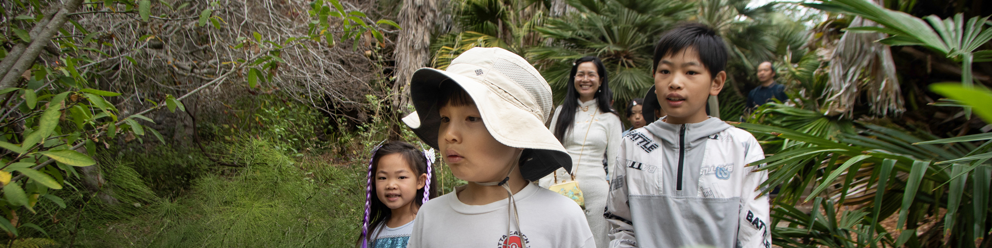 Happy Asian family walks in the Garden