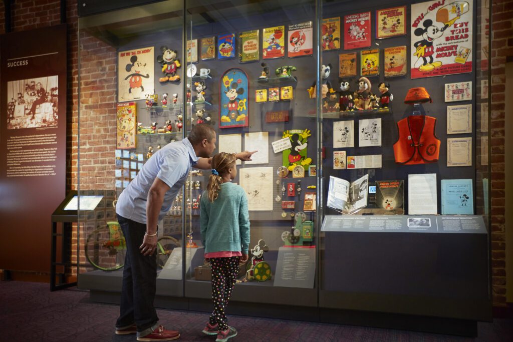 View full sized image of Visitors look at a display in a museum