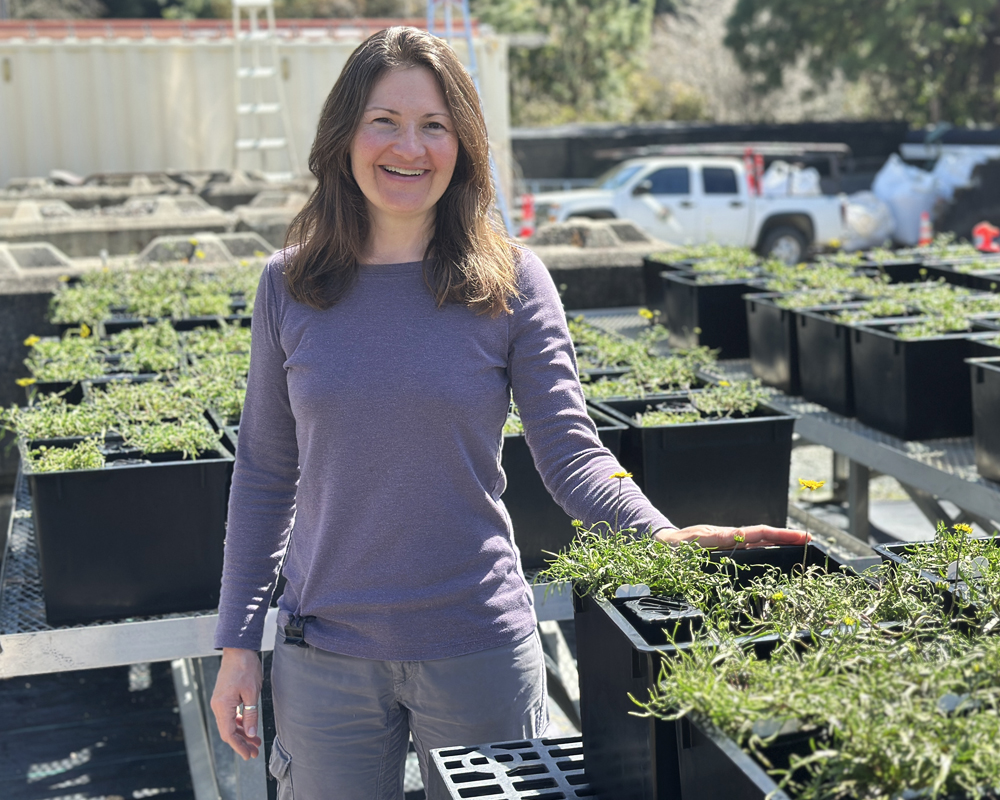 A smiling woman in a plant nursery